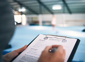 Image showing Hand, documents and sign up in a gym with a coach watching a performance for membership or contract. Paper, checklist and personal trainer in a sports center for fitness, planning or assessment