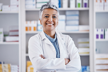 Image showing Senior woman, pharmacist and arms crossed in portrait for healthcare, medicine or entrepreneurship at store. Female pharma expert, happy and excited face for small business, service and wellness shop