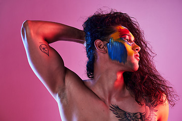 Image showing Creative, face paint and art with man in studio for beauty, self love and designer. Fantasy, neon and light with male model and colors on pink background for makeup, abstract and cosmetics mockup