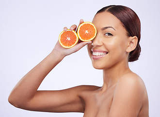 Image showing Skincare, orange and woman portrait in studio for vitamin c, treatment and cosmetics on purple background. Face, fruit and girl model relax with diy facial, organic or skin detox with citrus cleaning