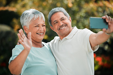 Image showing Senior couple, video call and phone in park, garden and contact on mobile voip communication. Retirement, old man and happy woman wave for selfie, smartphone and smile for hello, chat or online media