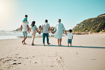 Image showing Family, walking and holding hands outdoor on a beach with children, parents and grandparents together. Men, women and boy kids walk at sea with love, care and quality time for summer travel vacation