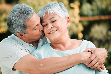 Image showing Senior couple, kiss and hug in park, garden and nature for love, care and happiness together. Happy man, woman and retirement of loving partner, relax and support in marriage, quality time or outdoor