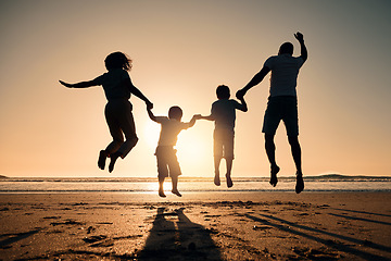 Image showing Beach silhouette, sunset and a family jump for freedom, summer energy or travel. Happy, nature and back of a mother, father and children holding hands while jumping at the ocean for celebration