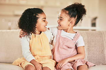 Image showing Happy, children and sisters hugging on a sofa while bonding in the living room of their home. Happiness, friendship and girl kids embracing while talking and spending quality time together in a house