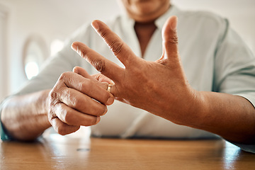Image showing Divorce, ring and hand of old woman at home for separation, breakup and conflict. Marriage problem, relationship issues and finish with wife finger and decision for change, disagree and leave