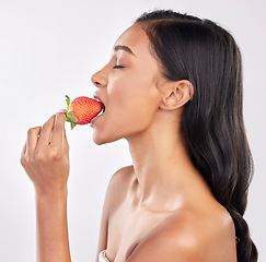 Image showing Woman, skincare and studio profile with strawberry, eating and wellness with beauty, natural glow and health. Model, diet and nutrition with fruit, cosmetics and healthy lifestyle by white background