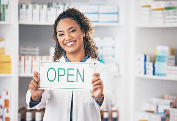 Image showing Open, business sign and woman portrait in a pharmacy with billboard from medical work. Working, pharmacist and healthcare worker with a smile from retail store opening and small business poster