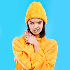 Image showing Portrait of woman in winter fashion with doubt, beanie and attitude isolated on blue background. Style, confused face of gen z girl and studio backdrop, model in warm clothes for cold weather mockup.