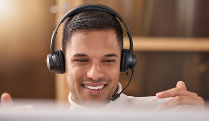 Image showing Call center, man and happy with smile on face at desk in office for sales and customer support, Male agent or consultant in telemarketing, support and crm with headphones for help desk communication