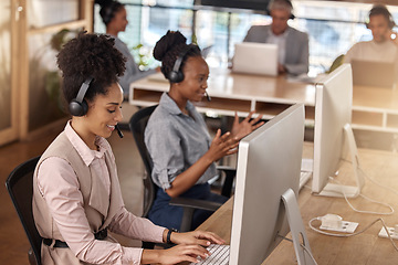 Image showing Call center, team and computer on desk in office for customer service, sales or support. Happy people, agents or consultant in night telemarketing, telecom and crm or help desk in coworking workplace