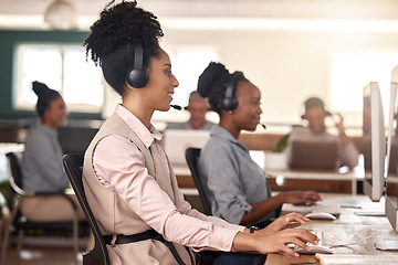 Image showing Call center, black woman and computer on desk in office for customer service, sales or support. Agent or consultant team in telemarketing, telecom and crm or help desk in coworking workplace