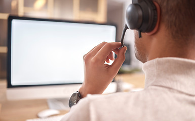 Image showing Call center, man and computer screen in office for customer service, sales or evening support. Male agent, consultant or headset microphone for telemarketing, telecom or crm help mockup on technology