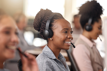 Image showing Call center, black woman and smile on face for sales, telemarketing and support. Professional female consultant or agent with a headset, mic and team for customer service, crm or help desk for advice