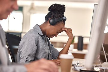 Image showing Call center, woman and stress or headache at computer in office and tired of sales or customer service. African female agent or consultant in telemarketing, support and crm with mental health burnout