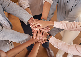 Image showing Business people, hands and teamwork in collaboration above for meeting trust, unity and community at office. Top view of group piling hand together for celebration, success or workplace team building