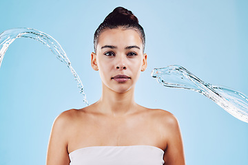 Image showing Portrait, skincare and woman with water, beauty and grooming against a blue studio background. Face cleaning, female and person with clear liquid, aqua and cosmetics for morning routine and hygiene