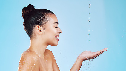 Image showing Water drops, skincare and woman with mockup for health, wellness and hygiene isolated on blue studio background. Shower, dermatology and cosmetic beauty glow, model in skin care treatment or routine