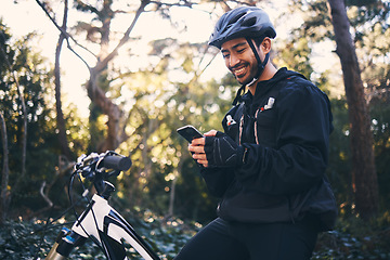 Image showing Sports, man and phone outdoor for mountain bike, cycling or workout and smile in nature. Male person in forest with smartphone in hands for communication, gps travel app or fitness with safety gear