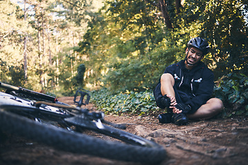 Image showing Sports man, injury and bicycle outdoor while cycling on mountain bike in nature with leg pain. Athlete person on ground in forest for fitness exercise, training or workout accident crash or fall