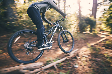 Image showing Cycling, speed and man on a bicycle on a dirt forest road doing training and exercise on a bike. Fast, outdoor trail and athlete with energy on a nature adventure or fitness on a path
