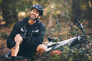 Image showing Forest, cycling and Asian man with knee pain, training and muscle tension in nature, emergency and accident. Male rider, athlete or person with bicycle, leg injury and outdoor for practice and strain