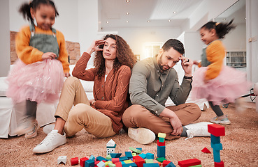 Image showing Family, girl playing and parents with stress, frustrated or in living room with a headache or burnout. Mother, father or female child with toys, busy or fast speed in lounge, home or hyper active kid