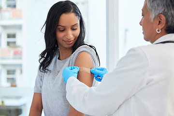 Image showing Healthcare, woman and doctor with plaster, vaccination and consultation in a hospital, cure and disease. Female patient, client and medical professional with care, vaccine and injection for safety