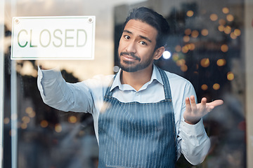 Image showing Portrait, business and Asian man with closed sign, coffee shop and closing with recession. Male employee, entrepreneur or manager closing restaurant, financial crisis or bankruptcy with loss of money