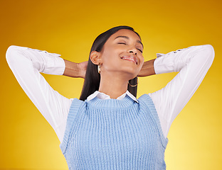 Image showing Relax, happy and woman in studio smile, chilling and satisfied against gradient yellow background. Peaceful, happiness and indian female content, cheerful and carefree while leaning and isolated