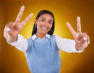 Image showing Hands, peace sign and portrait of Indian woman in studio for happiness, confident and smile on brown background. Emoji mockup, fashion and girl with hand gesture with beauty, cosmetics and style