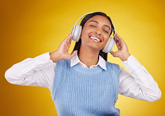 Image showing Music headphones, studio and happy woman listening to media sound track for fun, freedom and wellness. Energy, audio podcast or Indian person streaming radio, playlist or song on yellow background