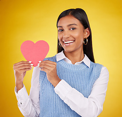 Image showing Happy, paper and heart with portrait of woman in studio for love, support and romance. Valentines day, kindness and date with female and symbol on yellow background for health, happiness and hope