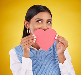 Image showing Shy, paper and heart with woman in studio for love, support and romance. Valentines day, kindness and date with female and hiding with symbol on yellow background for health, happiness or hope mockup