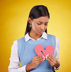 Image showing Sad, unhappy and woman with broken heart, depression and problems against a studio background. Female, depressed and person with tear, symbol for love cracked and issue after breakup and anxiety