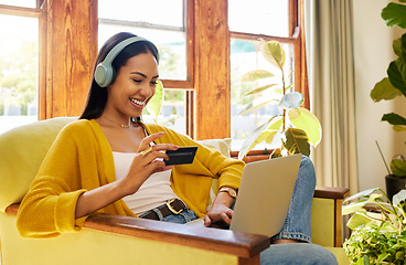 Image showing Happy woman, laptop and credit card with ecommerce and headphones to listen to music while online shopping. Female relax at home, radio streaming with fintech, internet banking and payment success