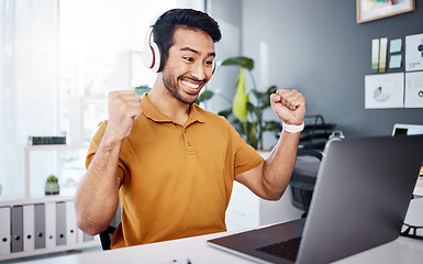 Image showing Business man, laptop and headphones to celebrate success while listening to music, audio or video call. Asian male entrepreneur at desk with a smile and hands for achievement, notification or goals