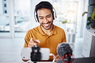 Image showing Podcast, pointing and live streaming with a man influencer recording broadcast content in his home office. Internet, streamer and subscription with a male freelancer or creator working in his studio