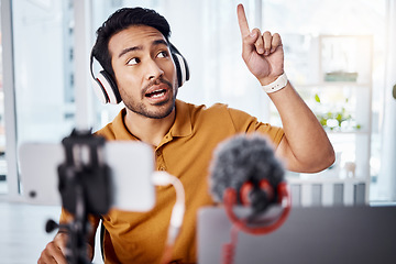 Image showing Podcast, pointing and live stream with a man influencer recording broadcast content in his home office. Internet, freelance and subscription with a male vlogger or creator working in his studio