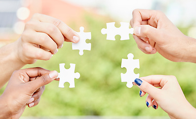 Image showing People, hands and puzzle outdoor for teamwork, solution and problem solving for innovation. Closeup of group, team building game and collaboration of cooperation, synergy and support of integration