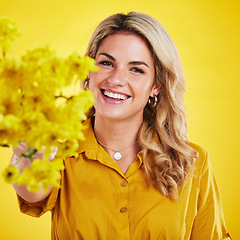 Image showing Portrait, smile and woman showing flowers in studio isolated on a yellow background. Floral, bouquet present and happiness of person or female model sharing natural plants and fresh flower for spring