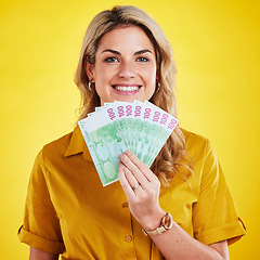 Image showing Smile, portrait and woman with money fan in studio isolated on a yellow background. Winner, financial freedom and rich female person with cash or euros after winning lottery, prize or competition.