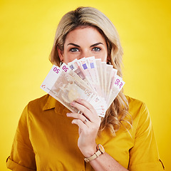 Image showing Portrait, euros and woman with money fan in studio isolated on a yellow background. Winner, financial freedom and rich female person with cash profit after winning lottery, bonus prize or competition