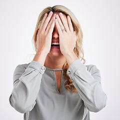 Image showing Comic, funny and embarrassed with a woman on a gray background in studio laughing at a joke. Smile, comedy and humor with a person enjoying a laugh or fun while covering her face in expression