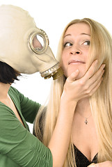Image showing two girls - one in gas mask