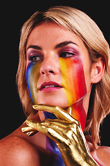 Image showing Woman, gold hand and beauty with color paint cosmetics on skin and face in studio. Female model person on a black background for art deco, fantasy and creative rainbow makeup for lgbtq or gay pride