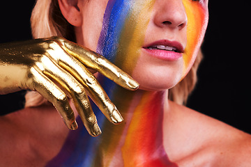 Image showing Woman, gold hand and beauty with color, paint or cosmetics on skin and face in studio. Female model person on a black background for art deco, fantasy and creative rainbow makeup or metallic closeup