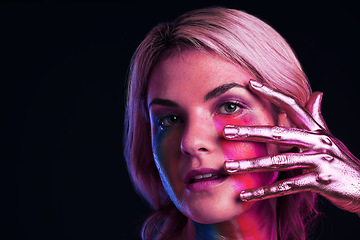 Image showing Woman, metallic hand and beauty portrait with color paint cosmetics on skin and face in studio. Female model person on a black background for art deco, fantasy and creative makeup with a neon light