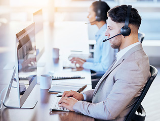 Image showing Call center, computer and business with man in office for customer service, technical support or help desk. Telemarketing, contact us or communication for employee and serious operator in tech advice