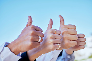 Image showing Business people, hands and thumbs up in agreement, thank you or good job for teamwork in the outdoors. Hand of group showing thumb emoji, yes sign or like for team success, ok or approval on blue sky